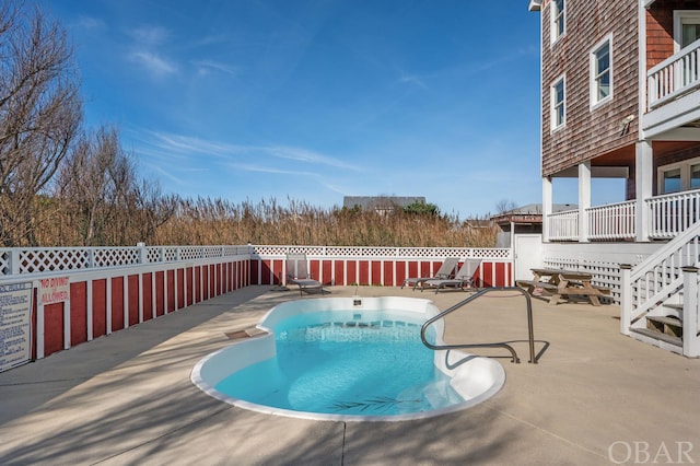 view of pool with a patio area, fence, and a fenced in pool