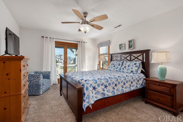 bedroom featuring access to outside, visible vents, ceiling fan, and light carpet