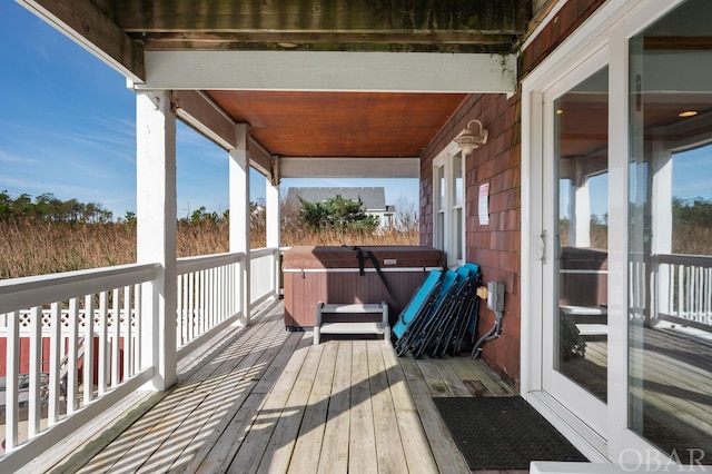 wooden deck featuring a hot tub