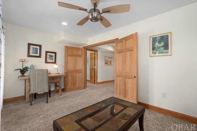 office featuring carpet floors, a ceiling fan, and baseboards