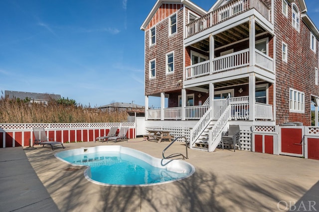 view of pool with a patio area, stairs, fence, and a fenced in pool