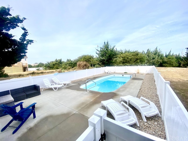 view of swimming pool featuring a fenced in pool, a patio area, and a fenced backyard