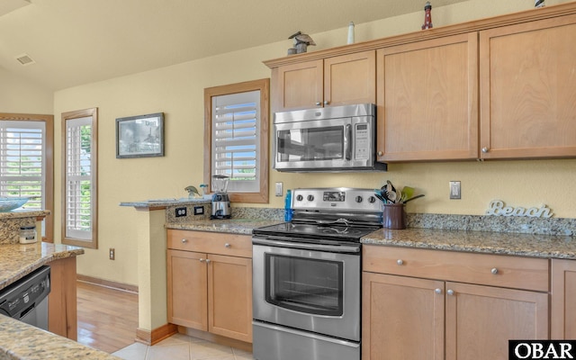 2132 Dolphin Ln Lot 62, Corolla, NC 27927 - kitchen featuring appliances with stainless steel finishes, light brown cabinetry, light stone countertops, and light wood-type flooring