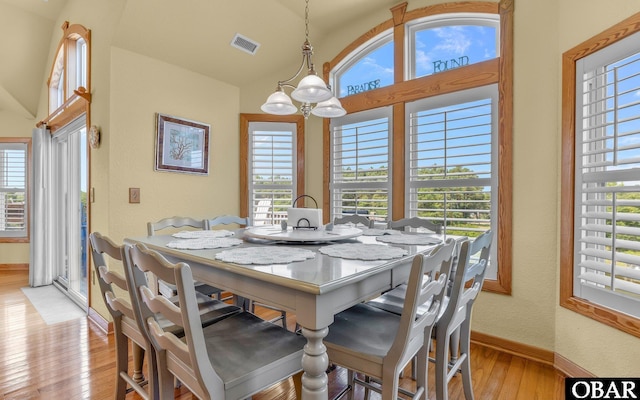 2132 Dolphin Ln Lot 62, Corolla, NC 27927 - dining space with lofted ceiling, light wood finished floors, healthy amount of natural light, and a chandelier