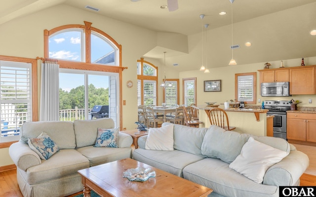 2132 Dolphin Ln Lot 62, Corolla, NC 27927 - living area with plenty of natural light, high vaulted ceiling, light wood-style floors, ceiling fan, and recessed lighting