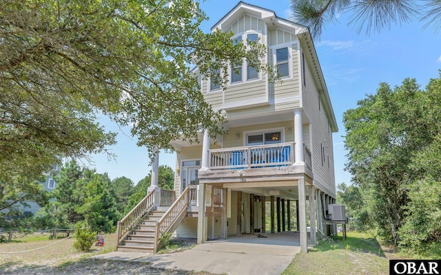 2132 Dolphin Ln Lot 62, Corolla, NC 27927 - beach home with a carport, stairs, a porch, and concrete driveway