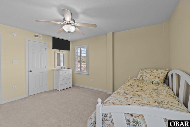 bedroom featuring ceiling fan, baseboards, visible vents, and light carpet