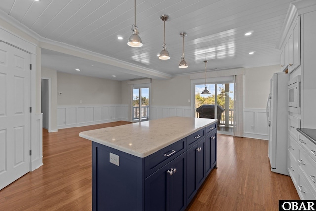 kitchen featuring blue cabinetry, white appliances, a kitchen island, and white cabinetry