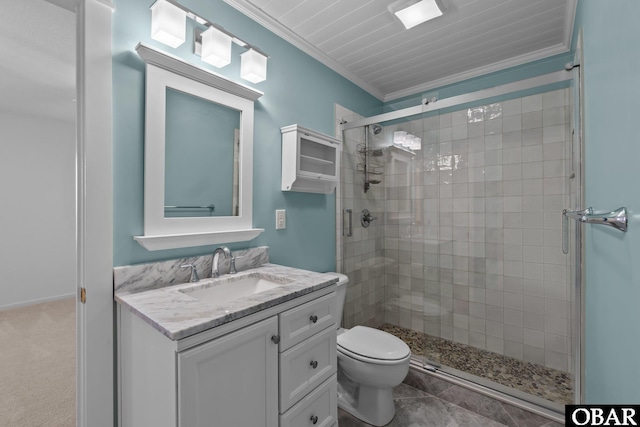 bathroom with vanity, toilet, a stall shower, and crown molding