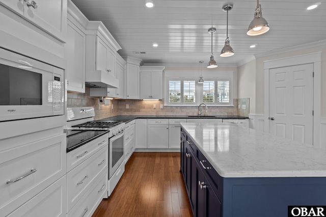 kitchen featuring a sink, white cabinetry, white appliances, exhaust hood, and crown molding