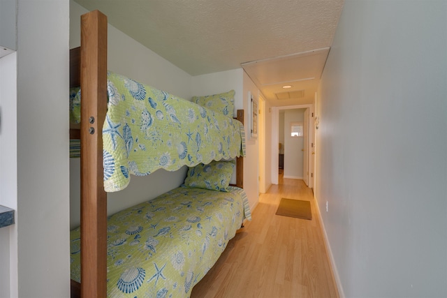 bedroom featuring light wood-style flooring and baseboards