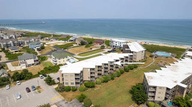 drone / aerial view with a beach view and a water view