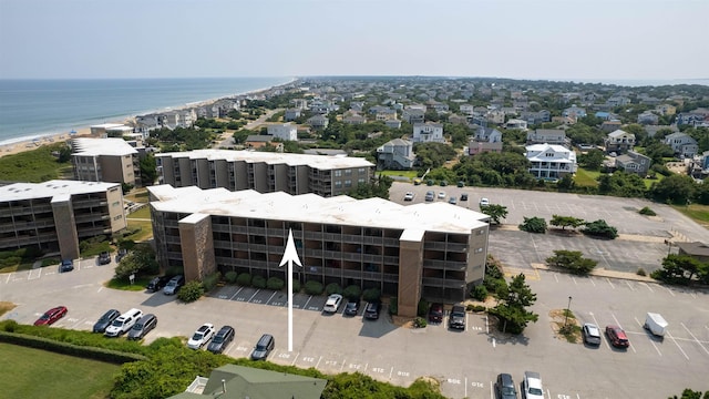 drone / aerial view featuring a beach view and a water view