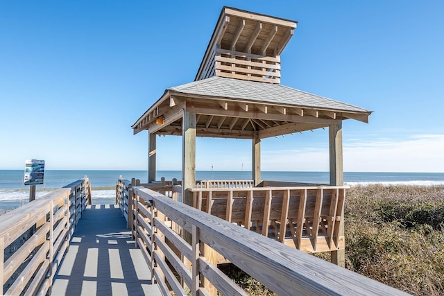 surrounding community featuring a gazebo, a beach view, and a water view