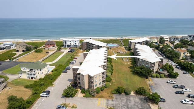 birds eye view of property with a beach view and a water view