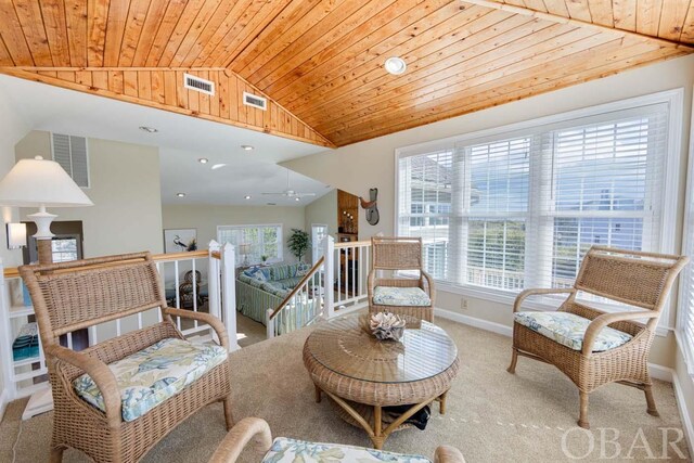 sitting room with carpet floors, lofted ceiling, wood ceiling, an upstairs landing, and baseboards