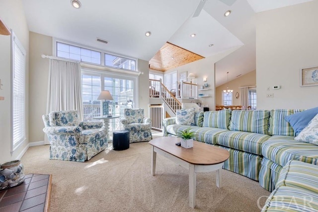 living room with carpet floors, recessed lighting, visible vents, high vaulted ceiling, and stairs