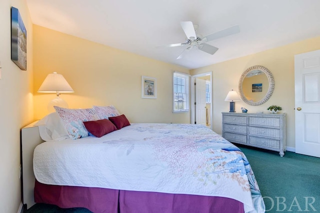 bedroom featuring a ceiling fan and dark colored carpet