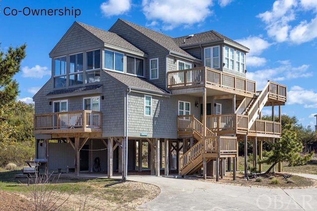 exterior space with stairs, a carport, and driveway