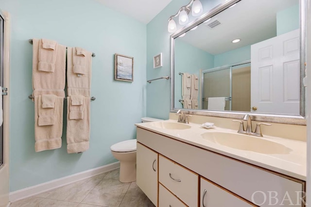 bathroom featuring visible vents, a sink, baseboards, and tile patterned floors