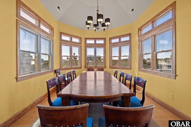 dining room with visible vents, vaulted ceiling, and a wealth of natural light