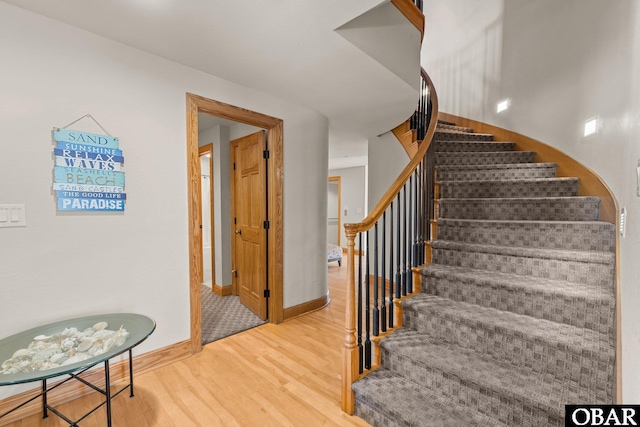 stairs featuring baseboards and wood finished floors