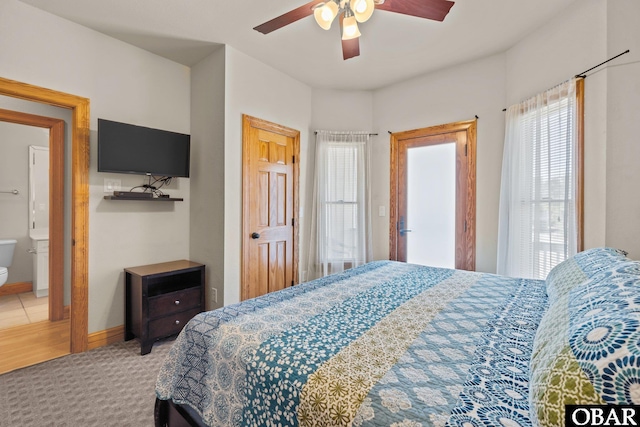 carpeted bedroom with baseboards and a ceiling fan