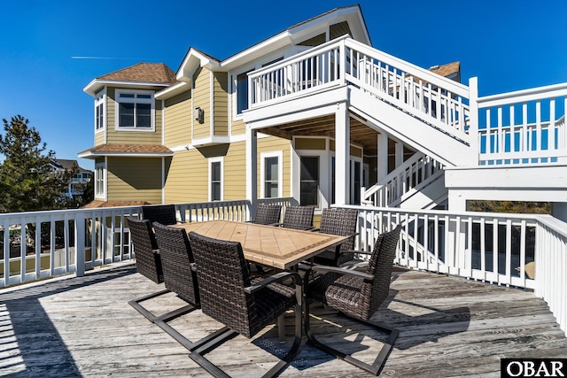 wooden terrace with stairs and outdoor dining space