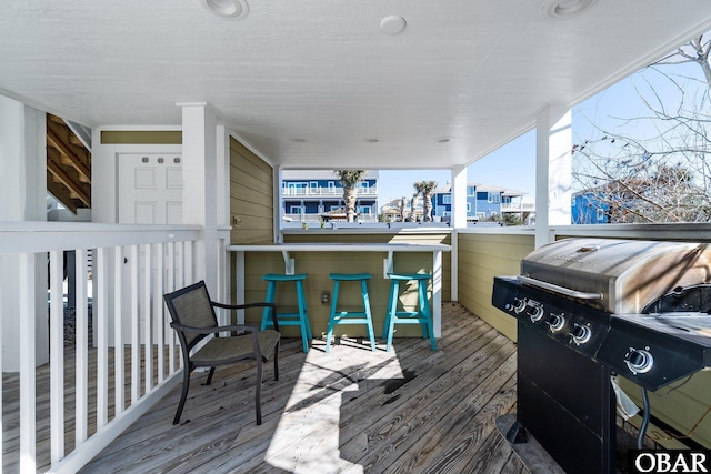 wooden deck with outdoor dry bar