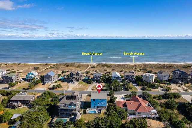 birds eye view of property featuring a water view, a residential view, and a view of the beach