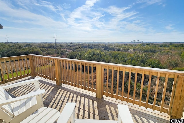 wooden deck with a forest view