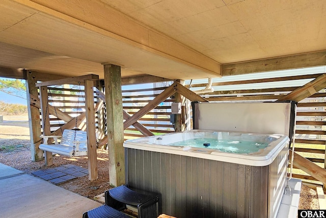 view of patio / terrace featuring a hot tub and stairway