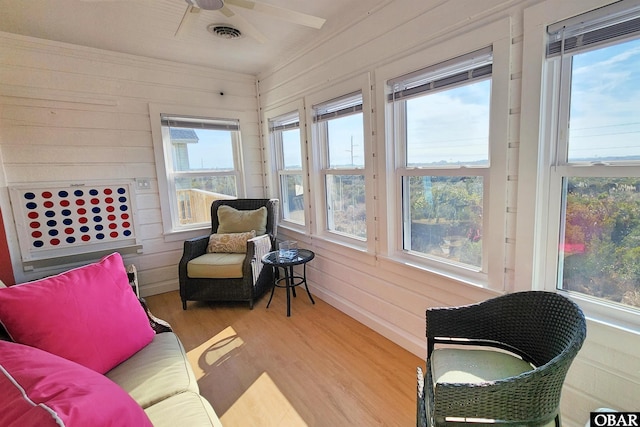 sunroom / solarium with plenty of natural light, visible vents, and a ceiling fan