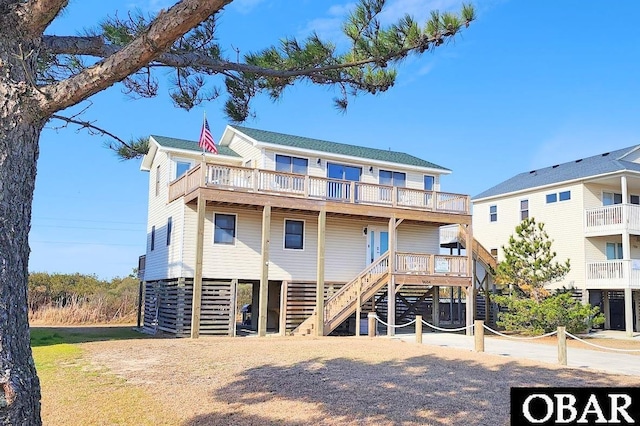 view of front of property with a balcony, stairs, and a wooden deck