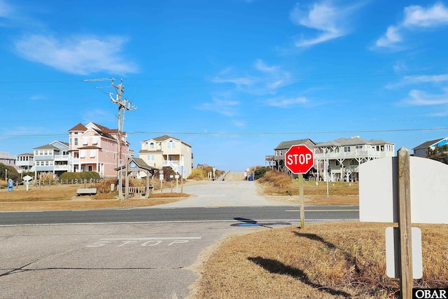 view of street featuring traffic signs and a residential view