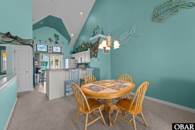 1108 Cambridge Rd Unit 307-I, Kill Devil Hills, NC 27948 - dining area with a chandelier, light carpet, high vaulted ceiling, and recessed lighting