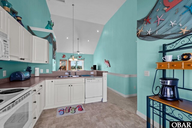 1108 Cambridge Rd Unit 307-I, Kill Devil Hills, NC 27948 - kitchen featuring white appliances, high vaulted ceiling, white cabinetry, dark countertops, and hanging light fixtures