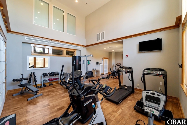 1108 Cambridge Rd Unit 307-I, Kill Devil Hills, NC 27948 - gym featuring a towering ceiling, wood finished floors, and recessed lighting