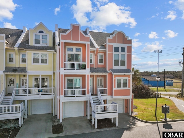 1108 Cambridge Rd Unit 307-I, Kill Devil Hills, NC 27948 - view of front of property featuring an attached garage, stairs, driveway, and roof with shingles