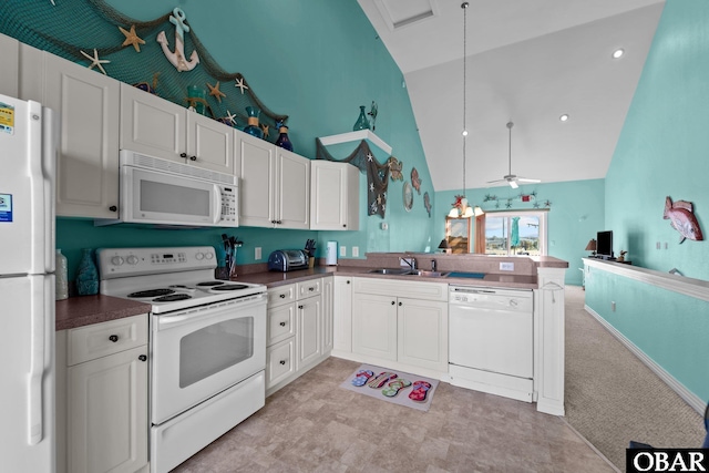 1108 Cambridge Rd Unit 307-I, Kill Devil Hills, NC 27948 - kitchen with white appliances, high vaulted ceiling, dark countertops, open floor plan, and white cabinetry