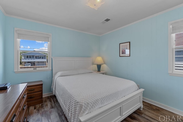 bedroom featuring baseboards, visible vents, dark wood-style flooring, and ornamental molding