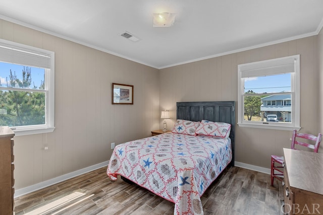 bedroom with ornamental molding, visible vents, dark wood finished floors, and baseboards