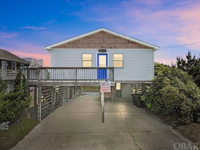 view of property exterior with a carport and concrete driveway