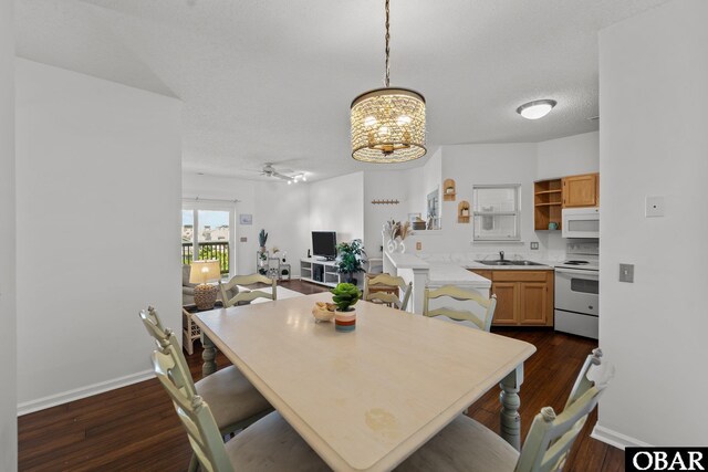 laundry area with stacked washer / drying machine, laundry area, baseboards, and wood finished floors