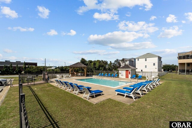 pool featuring a patio, a lawn, a gazebo, and fence