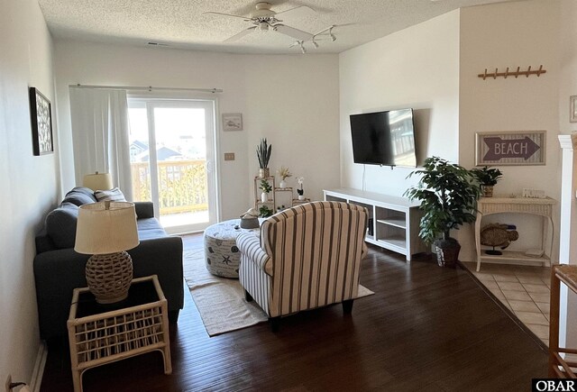 living area featuring visible vents and dark wood-type flooring