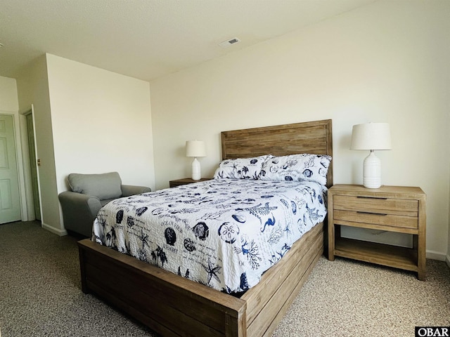 bedroom with carpet floors, visible vents, and baseboards