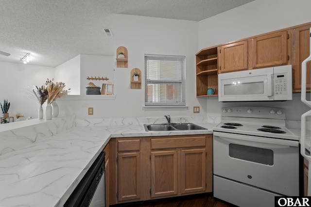 kitchen with white appliances, light stone countertops, a textured ceiling, open shelves, and a sink