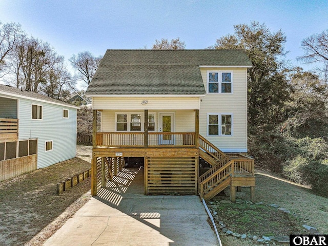 view of front of home featuring stairs, a carport, a porch, and driveway