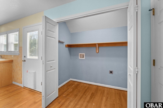 laundry room with washer hookup, light wood-style floors, electric dryer hookup, laundry area, and baseboards